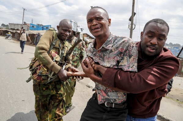 Police arrest a protester during clashes in the Mathare area of Nairobi, Kenya Wednesday, July 19, 2023. Kenyans were back protesting on the streets of the capital Wednesday against newly imposed taxes and the increased cost of living. (AP Photo/Brian Inganga)