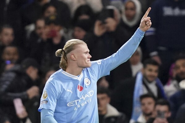 Manchester City's Erling Haaland celebrates scoring his side's third goal during the English Premier League soccer match between Chelsea and Manchester City at Stamford Bridge stadium in London, Sunday, Nov. 12, 2023. (John Walton/PA via AP)