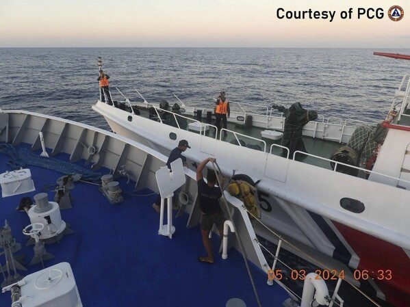 In this handout photo provided by the Philippine Coast Guard, a Chinese coast guard ship approaches a Philippine coast guard ship, foreground, causing a minor collision, in the vicinity of Second Thomas Shoal on Tuesday, March 5, 2024. The vessels collided in the disputed South China Sea, slightly injuring four Filipino crewmen in a new confrontation that unfolded as Southeast Asian leaders gathered for an Asian summit where alarm over Beijing’s aggression at sea was expected to be raised. (Philippine Coast Guard via AP)