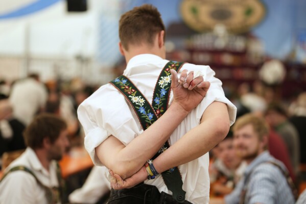 A competitor warms up for his bout while he try to pull the opponent over the table at the German Championships in Fingerhakeln or finger wrestling, in Pang, near Rosenheim, Germany, Sunday, April 27, 2025. (AP Photo/Matthias Schrader)