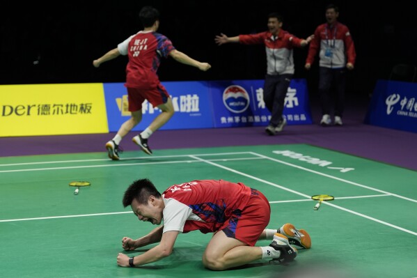 China's He Ji Ting runs to hug his coaches as Ren Xiang Yu celebrates on the court after defeating Indonesia's Muhammad Shohibul Fikri and Bagas Maulana to lead Team China to a 3-1 win over Team Indonesia in the final of the Thomas Cup held in Chengdu in southwestern China's Sichuan Province, Sunday, May 5, 2024. (AP Photo/Ng Han Guan)