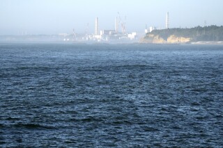 FILE - The Fukushima Daiichi nuclear power plant, damaged by a massive March 11, 2011, earthquake and tsunami, is seen from the nearby Ukedo fishing port in Namie town, northeastern Japan, on Aug. 24, 2023. The release of a third batch of treated radioactive wastewater from Japan's damaged Fukushima nuclear plant into the Pacific Ocean ended safely as planned, its operator said Monday, Nov. 20, as the country's seafood producers continue to suffer from a Chinese import ban imposed after the discharges began. (AP Photo/Eugene Hoshiko, File)