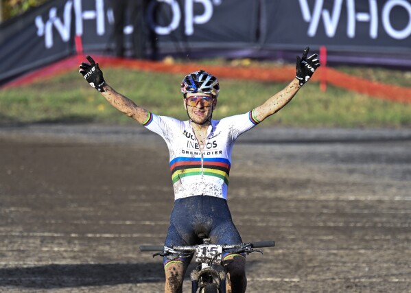 FILE - Thomas Pidcock, of Britain, celebrates after his victory at the men's elite class UCI mountain bike World Cup cross country cycling event in Beaupre, Quebec, Sunday, Oct. 8, 2023. The defending mountain bike gold medalist will be heavily favored to repeat. (Jacques Boissinot/The Canadian Press via AP, File)