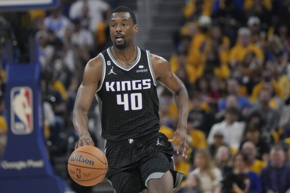 FILE - Sacramento Kings forward Harrison Barnes brings the ball up against the Golden State Warriors during Game 4 in an NBA basketball first-round playoff series in San Francisco, April 23, 2023. Barnes and the Kings agreed on a three-year, $54 million contract Thursday, June 29. (AP Photo/Jeff Chiu)
