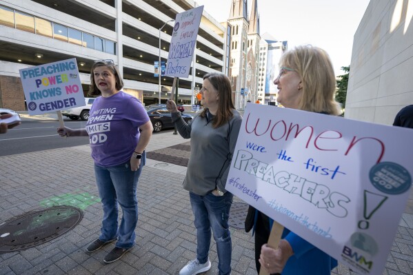 Nikki Hardeman, of Atlanta, Ga.,, an advocacy director for Baptist Women in Ministry, left, Meredith Stone, executive director of Baptist Women in Ministry, center, and Christa Brown, an advocate for survivors of sexual abuse and a supporter of the Baptist Women in Ministry, stand outside the venue of a Southern Baptist Convention annual meeting Tuesday, June 11, 2024, in Indianapolis. (AP Photo/Doug McSchooler)