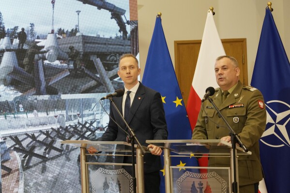 Polish armed forces' Chief of Staff. Gen Wieslaw Kukula, right , and Deputy Defense Minister Cezary Tomczyk, second right, speak about a program of strengthening the defense of NATO'S eastern flank in Warsaw, Poland, Monday, May, 27, 2024, during a presentation of a program to upgrade the security of Poland's border with Russia and Belarus, which is also European Union's eastern border. (AP Photo/Czarek Sokolowski)