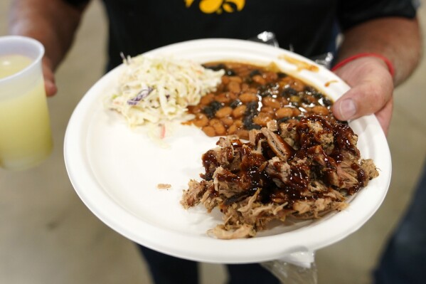 FILE - A plate of food is held on Aug. 6, 2023, in Cedar Rapids, Iowa. A new United Nations report estimates that 19% of the food produced around the world went to waste in 2022. (AP Photo/Charlie Neibergall, File)