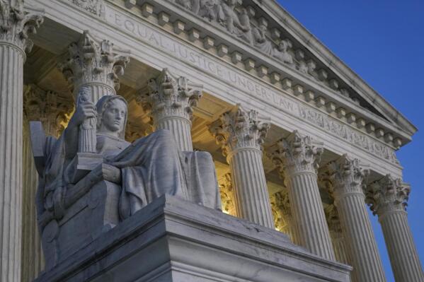 FILE- Light illuminates part of the Supreme Court building on Capitol Hill in Washington, Nov. 16, 2022. (AP Photo/Patrick Semansky, File)