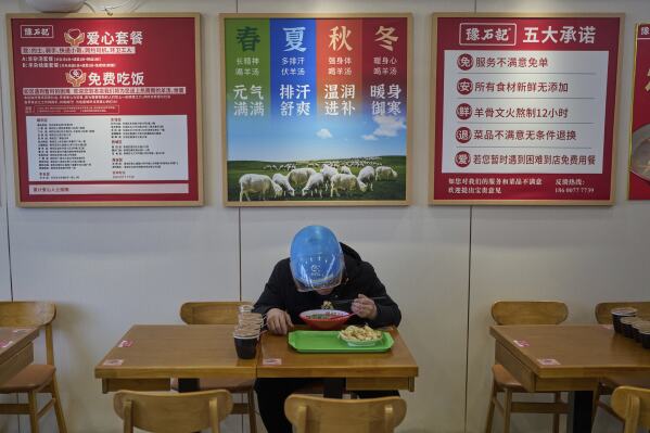 Liu Lijie, a food delivery rider from Ele.me eats his meal at Yushiji restaurant offering the “aixincan” or “loving meals," in Beijing on March 18, 2025. (AP Photo/Andy Wong)
