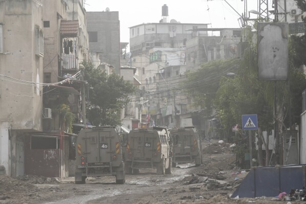 Israeli security forces during a raid in the Tulkarm refugee camp, in the West Bank, Wednesday, January 17, 2024. An Israeli airstrike killed four Palestinians during a raid in the West Bank.  The army said it targeted a group of gunmen who opened fire and threw explosives at Israeli soldiers in the Tulkarm refugee camp.  The Palestinian Ministry of Health says four people were killed.  (AP Photo/Nasser Nasser)