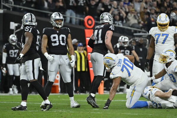 Las Vegas Raiders defensive tackle Jerry Tillery (90) celebrates after making a sack against the Los Angeles Chargers during the first half of an NFL football game, Thursday, Dec. 14, 2023, in Las Vegas. (AP Photo/David Becker)