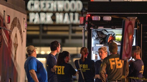 FILE - FBI agents gather at the scene of a deadly shooting, July 17, 2022, at the Greenwood Park Mall in Greenwood, Ind. The cellphone of a 20-year-old man who fatally shot three people at the Indianapolis-area mall in 2022 contained photos of Adolf Hitler, Nazi propaganda and firearms and also “extremely graphic" videos of previous mass killings, police said Thursday, July 13, 2023. (Kelly Wilkinson/The Indianapolis Star via AP, File)