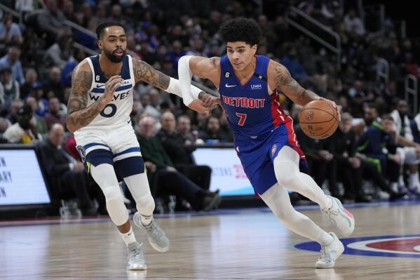 Detroit Pistons guard Killian Hayes (7) drives on Minnesota Timberwolves guard D'Angelo Russell (0) in the first half of an NBA basketball game in Detroit, Wednesday, Jan. 11, 2023. (AP Photo/Paul Sancya)