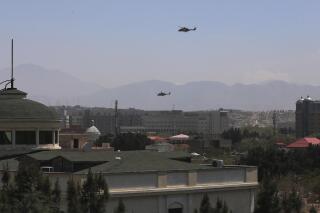 U.S. Black Hawk military helicopters fly over the city of Kabul, Afghanistan, Monday, April 19, 2021. (AP Photo/Rahmat Gul)