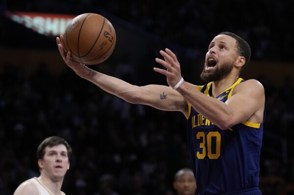 Golden State Warriors guard Stephen Curry (30) shoots during the first half of an NBA basketball game against the Los Angeles Lakers in Los Angeles, Saturday, March 16, 2024. (AP Photo/Ashley Landis)