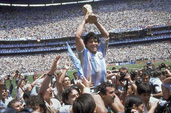 FILE - Argentina's Diego Maradona, celebrates at the end of the World Cup soccer final game against West Germany at the Atzeca Stadium, in Mexico City, June 29, 1986. The heirs of the late soccer star Diego Maradona have won a legal battle over the use of his trademark. Maradona had registered his name as a trademark with the European Union Intellectual Property Office in 2008 for a variety of products, clothing, footwear and headgear. The general court of the European Union confirmed Tuesday that it declined to transfer the trademark to Sattvica, an Argentine company belonging to Maradona’s former lawyer. Maradona died in November 2020. (AP Photo/Carlo Fumagalli, File)