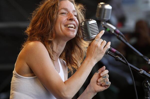 FILE - In this May 6, 2012 file photo, Ani DiFranco performs with the Preservation Hall Jazz Band at the New Orleans Jazz and Heritage Festival in New Orleans.  DiFranco is the honoree and will perform at the 41st annual John Lennon tribute concert in December in New York.  DiFranco shares a drive toward social activism with the late Beatle, a point noted in a statement from his widow Yoko Ono. (AP Photo/Gerald Herbert, File)
