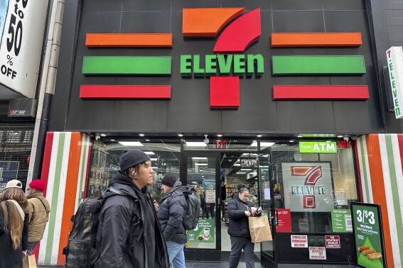 FILE - People shop at a 7-Eleven convenience store in New York, Tuesday, March 19, 2024. (AP Photo/Ted Shaffrey)