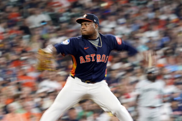 In this image taken with a slow shutter speed, Houston Astros starting pitcher Framber Valdez throws against the Minnesota Twins during the seventh inning of a baseball game Saturday, June 1, 2024, in Houston. (AP Photo/David J. Phillip)