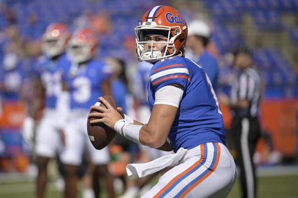 FILE -Florida quarterback Jalen Kitna (11) warms up before an NCAA college football game against Eastern Washington, Sunday, Oct. 2, 2022, in Gainesville, Fla. Florida backup quarterback Jalen Kitna, the son of retired NFL quarterback Jon Kitna, was arrested Wednesday, Nov. 30, 2022 and charged with two counts of distribution of child exploitation material and three counts of possession of child pornography. (AP Photo/Phelan M. Ebenhack, File)