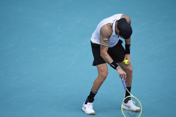 Matteo Berrettini, of Italy, stumbles and appears lightheaded, before returning to his bench mid-game to be checked by team staff, in his first round match against Andy Murray, of Britain, at the Miami Open tennis tournament, Wednesday, March 20, 2024, in Miami Gardens, Fla. (AP Photo/Rebecca Blackwell)