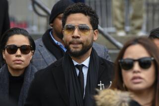 FILE - In this Feb. 24, 2020 file photo, former "Empire" actor Jussie Smollett leaves the Leighton Criminal Courthouse in Chicago, after an initial court appearance on a new set of charges alleging that he lied to police about being targeted in a racist and homophobic attack in downtown Chicago early last year. Two brothers who have admitted to helping Smollett stage a racist and homophobic attack in Chicago last year are threatening to stop cooperating with prosecutors. (AP Photo/Matt Marton File)