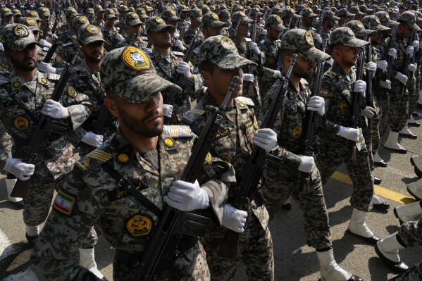 Iranian army members march during Army Day parade at a military base in northern Tehran, Iran, Wednesday, April 17, 2024. In the parade, President Ebrahim Raisi warned that the 