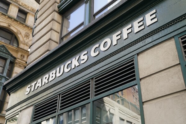 FILE - A Starbucks sign is displayed above a store in the Financial District of Lower Manhattan, Tuesday, June 13, 2023, in New York. Starbucks reports earnings on Tuesday, Aug. 1. (AP Photo/John Minchillo, File)