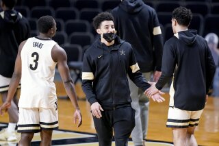 Vanderbilt's Scotty Pippen Jr., center, greets teammates before an NCAA college basketball game Wednesday, Feb. 24, 2021, in Nashville, Tenn. Pippen did not warm up with the team. Pippen is the SEC's second-leading scorer averaging 20.5 points a game and had started every game this season. This snaps a 32-game start streak. (AP Photo/Mark Humphrey)