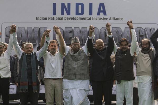 FILE- Leaders from the opposition INDIA alliance raise their hands together in a show of unity during a protest rally against the suspension of more than 140 lawmakers from the parliament, in New Delhi, India, Dec. 22, 2023. Last year more than two dozen opposition parties in India came together to take on Narendra Modi, one of the country's most popular prime ministers in generations. But the broad alliance, beset with ideological differences and personality clashes, is cracking at a crucial time, just months before the country votes in a national election. (AP Photo/Altaf Qadri, File)