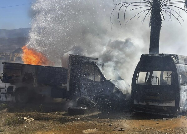 A truck and ambulance burn after Israeli airstrikes hit a group of paramedics outside a hospital in Marjayoun, south Lebanon, Friday, Oct. 4, 2024. (AP Photo)