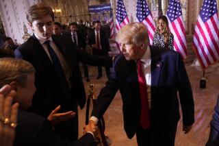 Former President Donald Trump greets people after announcing he is running for president for the third time as he speaks at Mar-a-Lago in Palm Beach, Tuesday, Nov. 15, 2022. Son Barron Trump watches. (AP Photo/Andrew Harnik)