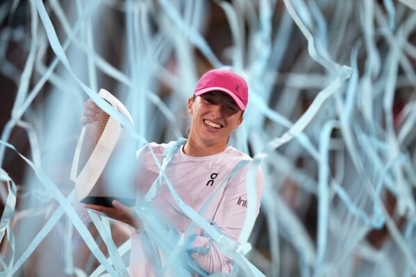 Poland's Iga Swiatek holds the trophy after winning the women's final against Belarus' Aryna Sabalenka at the Mutua Madrid Open tennis tournament held in Madrid, Spain on Saturday, May 4, 2024. player.  (AP Photo/Bernat Armang)