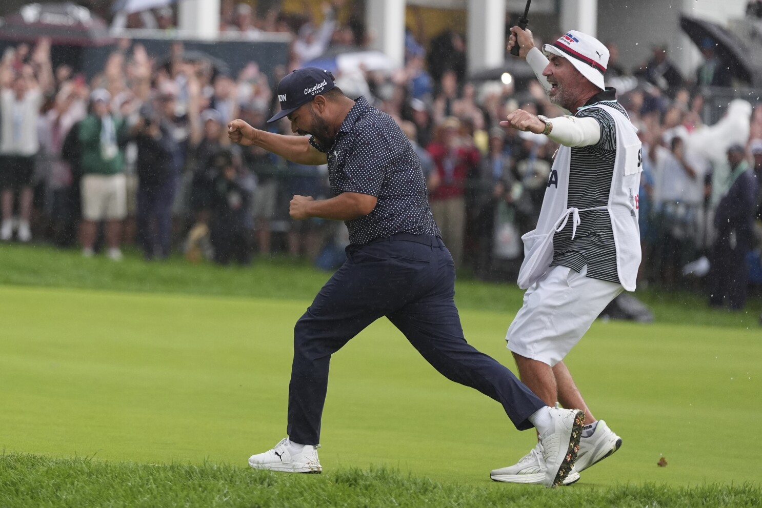 A caddie at heart, Bones Mackay makes sure to get the 18th flag to Spaun's bagman