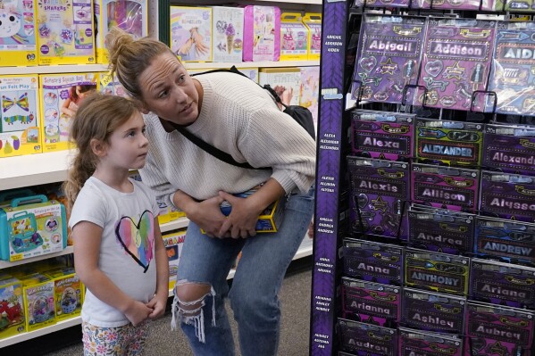 Quinn Byrne, 5 left, shops with her mother, Jamie Byrne, at a Learning Express store in Lake Zurich, Ill., Tuesday, Sept. 26, 2023. While still in its early phase, a growing number of toy marketers are embracing MESH — or mental, emotional and social health — as a designation for toys that teach kids skills like how to adjust to new challenges, resolve conflict, advocate for themselves, or solve problems. (AP Photo/Nam Y. Huh)
