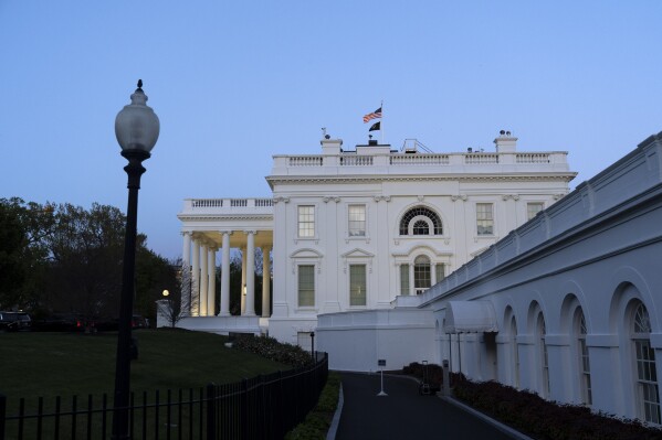 The White House is seen as dusk falls, Sunday, April 14, 2024, in Washington. (AP Photo/Jacquelyn Martin)