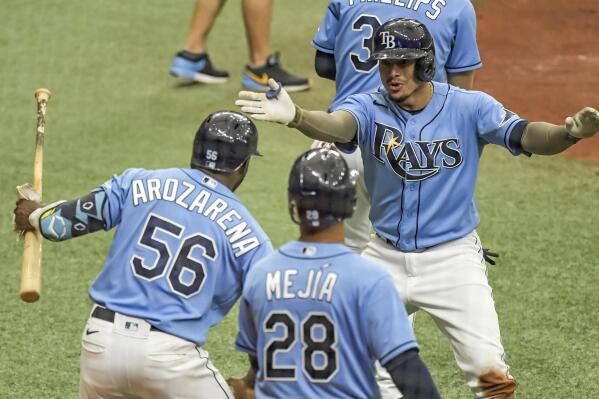 Tampa Bay Rays' Randy Arozarena (56) and Francisco Mejia (28) congratulate Willy Adames after his two-run home run off New York Mets' Marcus Stroman during the fifth inning of a baseball game Sunday, May 16, 2021, in St. Petersburg, Fla. (AP Photo/Steve Nesius)
