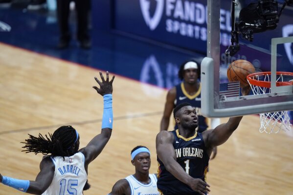 New Orleans Pelicans forward Zion Williamson (1) goes to the basket against Los Angeles Lakers center Montrezl Harrell (15) during the second half of an NBA basketball game in New Orleans, Tuesday, March 23, 2021. (AP Photo/Gerald Herbert)