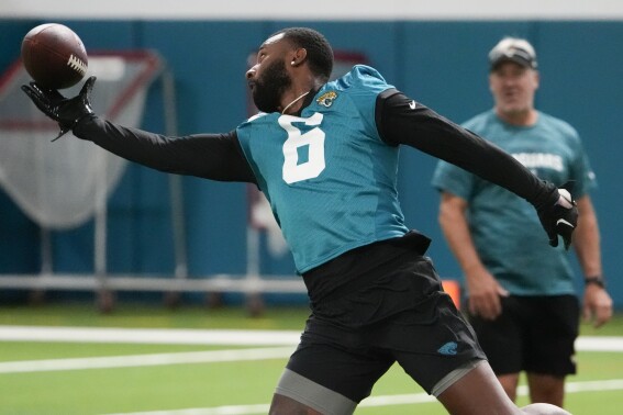 Wide receiver Jarvis Landry (6) reaches for a pass as head coach Doug Pederson looks on during the Jacksonville Jaguars NFL rookie camp football practice, Friday, May 10, 2024, in Jacksonville, Fla. (AP Photo/John Raoux)