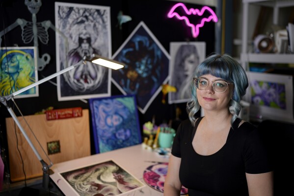 Kelly McKernan poses for a portrait Tuesday, Aug. 15, 2023, in Nashville, Tenn. McKernan is an artist and one of three plaintiffs in a lawsuit against Artificial Intelligence companies they allege have have infringed on their copyright. (AP Photo/George Walker IV)
