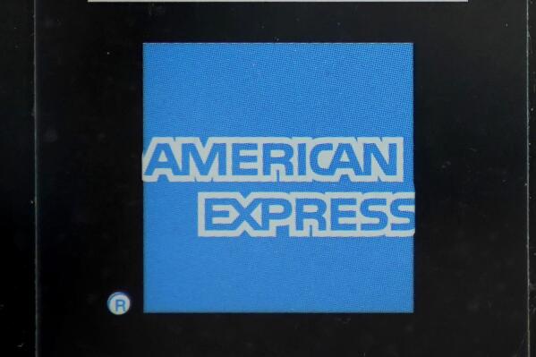 An American Express logo is attached to a door in Boston's Seaport District, Wednesday, July 21, 2021.  American Express Co.’s second-quarter revenue surged as people started spending more at a time when many are getting vaccinated against COVID-19 and feel more comfortable going out to restaurants, shops and entertainment venues again.   (AP Photo/Steven Senne)