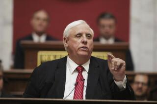 FILE - In this Wednesday, Jan. 8, 2020, file photo, West Virginia Governor Jim Justice delivers his annual State of the State address in the House Chambers at the state capitol, in Charleston, W.Va. Gov. Justice confirmed on Tuesday, June 1, 2021, that he is personally liable for $700 million in loans taken by his coal companies from a lender in the United Kingdom that went bankrupt. The Republican governor took shots at the bankrupt Greensill Capital U.K. and said “it is a burden on our family beyond belief.” (AP Photo/Chris Jackson, File)
