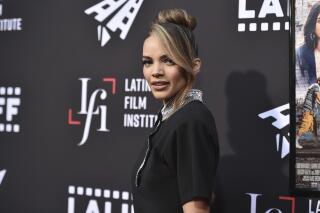 FILE - Leslie Grace arrives at a screening of "In the Heights" during the Los Angeles Latino International Film Festival on June 4, 2021. Warner Bros. has axed the $90 million “Batgirl” film planned for HBO Max, according to a person connected with the film who was not authorized to speak publicly about it. The studio decided the film, starring Grace in the title role, didn’t merit either a streaming debut or a theatrical release, and has instead opted to entirely write off the film which also starred Michael Keaton, J.K. Simmons and Brendan Fraser.  (Photo by Richard Shotwell/Invision/AP, File)