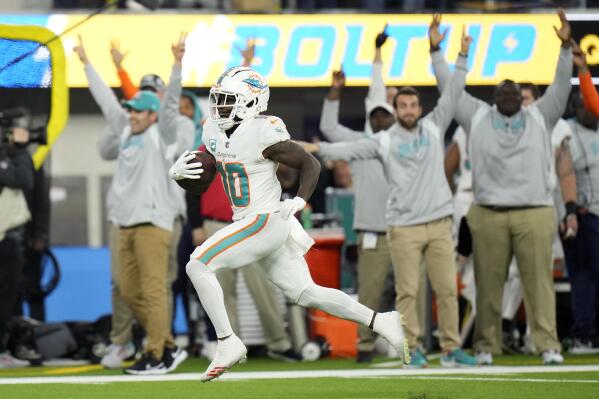 Miami Dolphins wide receiver Tyreek Hill (10) runs for a touchdown after recovering a fumble during the first half of an NFL football game against the Los Angeles Chargers Sunday, Dec. 11, 2022, in Inglewood, Calif. (AP Photo/Jae C. Hong)