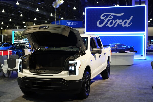 FILE - The Ford F-150 Lightning displayed at the Philadelphia Auto Show, Jan. 27, 2023, in Philadelphia. Ford will drastically cut the number of hourly workers at its factory that builds the Ford F-150 Lightning as sales of electric vehicles slow, according to a media report, Thursday, March 28, 2024. (AP Photo/Matt Rourke, File)