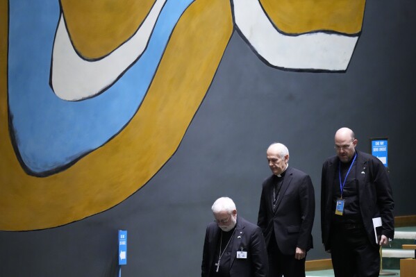 Members of the Holy See delegation make their way through the hall during the 78th session of the United Nations General Assembly, Saturday, Sept. 23, 2023 at United Nations headquarters. (AP Photo/Mary Altaffer)