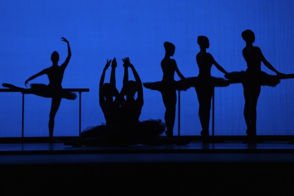 American Ballet Theatre's dancers are silhouetted as they rehearse for the opening night at the Shanghai Grand Theater in Shanghai, Thursday, Nov. 2, 2023. The American national ballet company is returning to China for the first time in a decade. (AP Photo/Ng Han Guan)