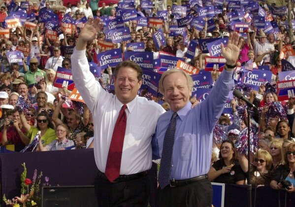 FILE - Democratic presidential candidate Vice President Al Gore, left, and his running mate, vice presidential candidate Sen. Joe Lieberman, of Connecticut, wave to supporters at a campaign rally in Jackson, Tenn., Oct. 25, 2000. Lieberman, who nearly won the vice presidency on the Democratic ticket with Gore in the disputed 2000 election and who almost became Republican John McCain's running mate eight years later, has died Wednesday, March 27, according to a statement issued by his family. He was 82. (AP Photo/Stephan Savoia, File)