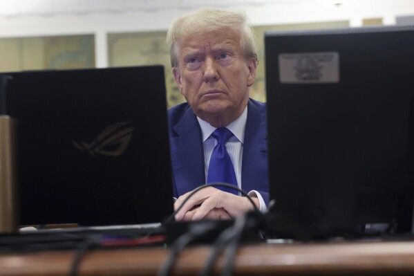 Former President Donald Trump waits for the continuation of his civil business fraud trial at New York Supreme Court, Wednesday, Oct. 25, 2023, in New York. (Spencer Platt/Pool Photo via AP)