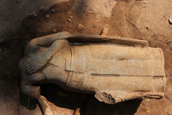 This February 2025 image provided by the Apsara National Authority, shows a headless statue excavated by archaeologists at the Angkor temple complex in Cambodia's Siem Reap province. According to archaeologists, the head of the same statue was dug up in 1927 and is now in Cambodia's National museum in the capital Phnom Penh, and the two parts may be reattached for display. (Apsara National Authority via AP)